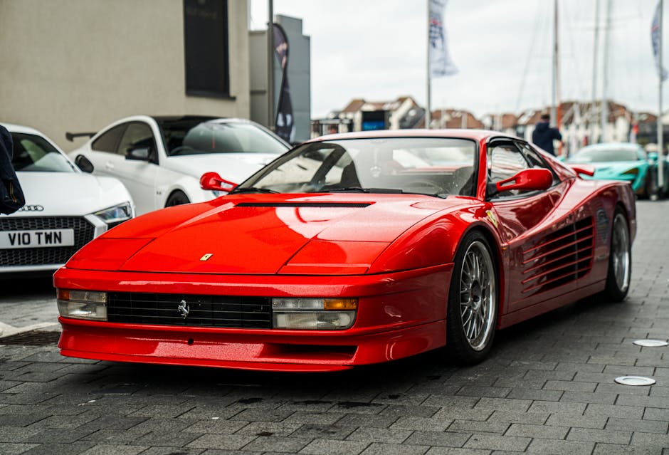 Vintage red sports car prominently displayed in a Southampton street, surrounded by modern vehicles.