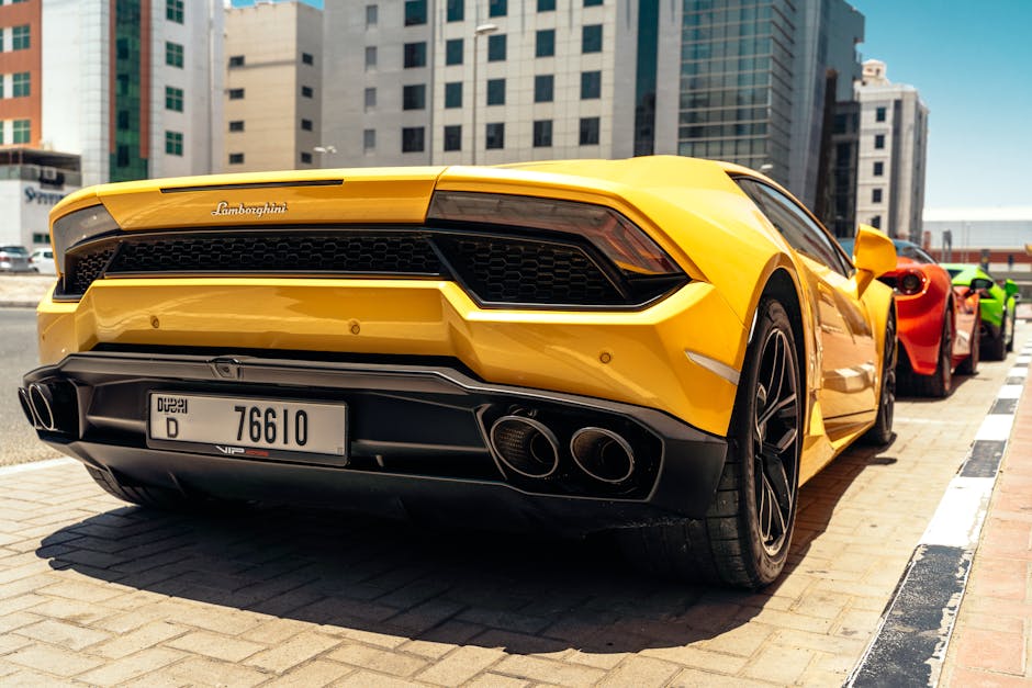 Stunning yellow Lamborghini sports car parked in downtown Dubai, showcasing luxury and speed.